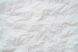 Wrinkled or crumpled white stencil paper or tissue after use in toilet or restroom with large copy space used for background texture in decorative art work. photo