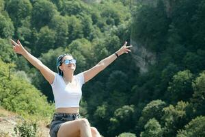 beautiful young woman with afro locks hiking in mountains photo