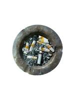 image of an iron ashtray full of cigarette butts and cigarette ashes on a white background photo