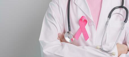 Pink October Breast Cancer Awareness month, doctor with pink Ribbon in hospital for support people life and illness. National cancer survivors month, Mother and World cancer day concept photo