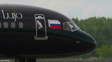 NOVOSIBIRSK, RUSSIAN FEDERATION JULY 15, 2022 - Side view of plane Azur Air with Lujo Art Joy Livery on the runway at Airport. Tourism and travel concept video