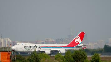 NOVOSIBIRSK, RUSSIAN FEDERATION JUNE 17, 2020 - Cargo airplane Boeing 747 of Cargolux taxiing at Tolmachevo airport, side view. Freight transport carrier. Haze on airfield video