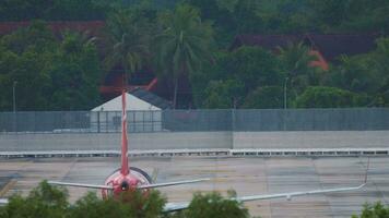 Civil aircraft on the airfield of the airport, rear view. Airliner on a background of palm trees. Airport on a tropical island. Tourism and travel concept video