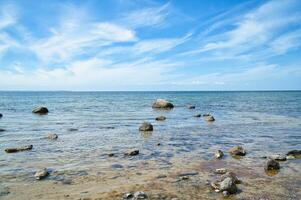 Stones and rocks on the Baltic coast in the sea. Landscape shot in sunshine. photo