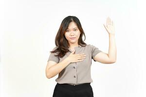 Swearing Gesture, Make an Oath Of Beautiful Asian Woman Isolated On White Background photo