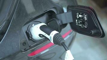 Open - close lid charging, Close up hand man  inserting plug into charging electric car. video
