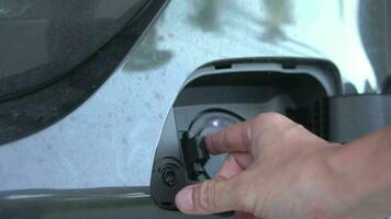 Open - close lid charging, Close up hand man  inserting plug into charging electric car. video