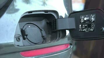 Open - close lid charging, Close up hand man  inserting plug into charging electric car. video