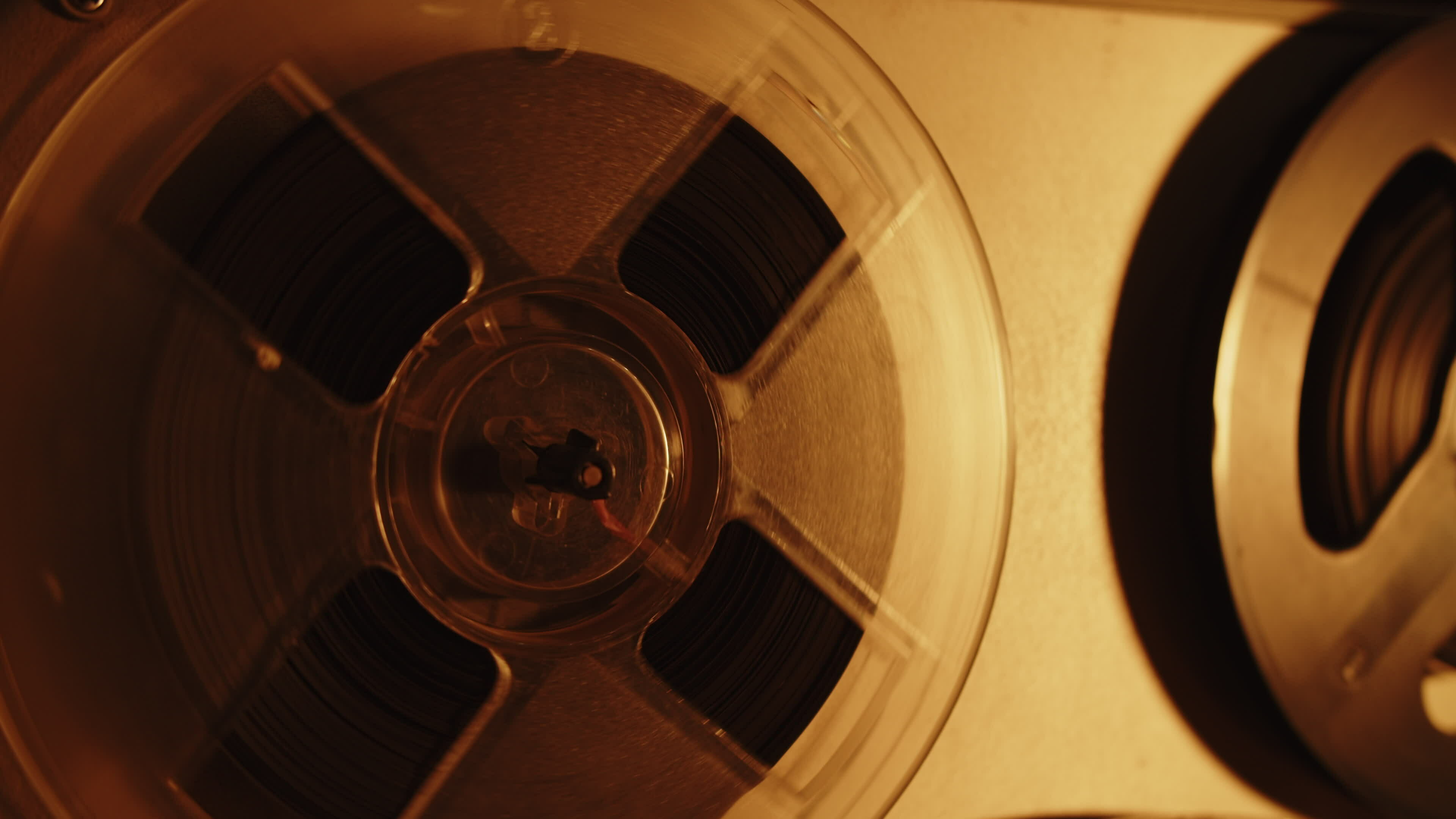 An old audio tape reel spinning. Sound tape. 27991522 Stock