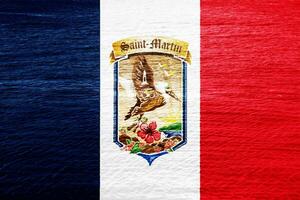 Flag and coat of arms of Collectivity of Saint Martin on a textured background. Concept collage. photo