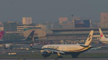 BANGKOK, THAILAND MARCH 01, 2023 - Jet plane Airbus A350 of Starlux braking after landing at Suvarnabhumi Airport, side view. Cinematic footage of aircraft on runway. Airplane arriving video