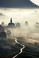 Silhouette of church in misty village landscape viewed from above photo