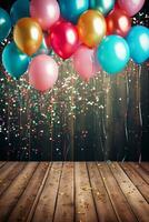Colorful balloons and confetti against a backdrop of wood photo