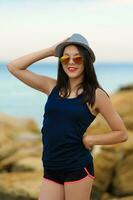 Young smiling girl in grey hat and sun glasses photo