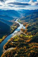 Aerial footage captures autumn's beautiful forest colors and epic mountain landscape during a flight photo