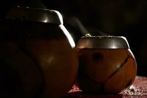 Two yerba mate calabashes with smoke. photo