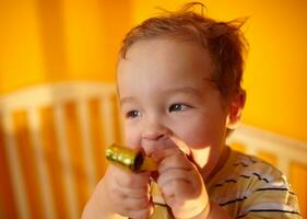 Portrait of the boy playing in playpen. photo