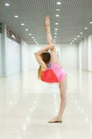 Young girl stretching out indoor photo