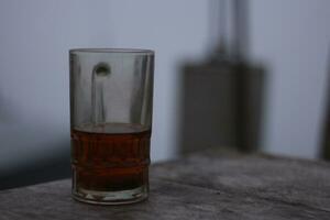 Glass of hot tea against a background of thick fog on a dry summer day. photo