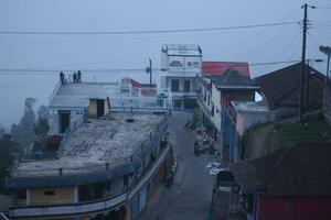 houses on the slopes of a cleft mountain in Indonesia photo