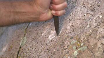 uralt Mann Höhle Gemälde und Schreiben historisch Inschrift Graffiti auf Felsen Oberfläche mit Eisen Meißel video