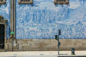 Azulejo tile in Porto, Portugal. Traditional portuguese ceramic decoration blue color. Historic building wall facade. photo