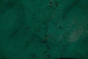 Grunge cracked forest green wall background photo