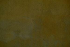 Dingy dark ochre painted wall background texture photo