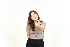 An Asian woman is showing the Korean love sign with a white background, smiling brightly photo
