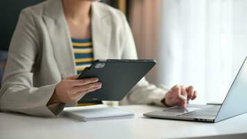 business woman working with digital tablet computer and smart phone with financial business strategy layer effect on desk video