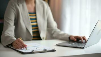 business woman working with digital tablet computer and smart phone with financial business strategy layer effect on desk video