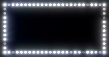 Abstract beauty frame of glowing white lights and light bulbs glowing bright magical energy on a black background photo