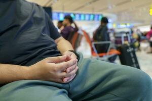 Man waiting for flight in airport departure area at airport waiting the flight photo