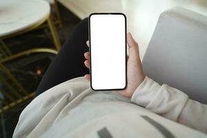 Women's hands holding cell telephone blank copy space screen. smartphone with blank white screen isolated. smart phone with technology concept photo