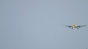 Front view of jet airplane landing at dusk. Planes lined up in the sky. Tourism and travel concept video