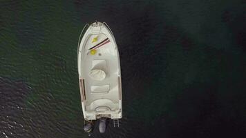 Flying over the lonely motor boat in vast blue sea video