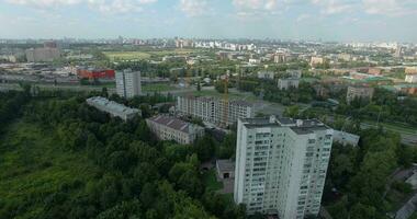 An aerial view of a sunny urbanscape among green trees video