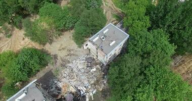 Aerial - half demolished old panel apartment house video