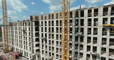 Aerial view of unfinished residential complex with builders working video