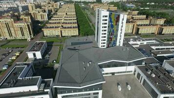 An aerial view of the residential district with similar looking beige buildings and green trees video