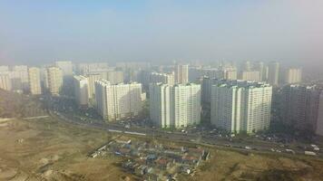 An aerial view of a large construction site and a residential area behind it video