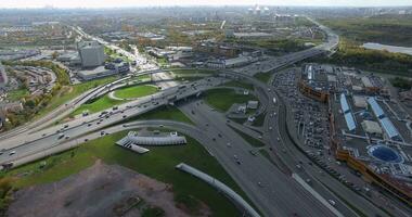 An aerial view of a sunny urbanscape with a road junction in the middle video