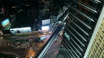 Time lapse night view of big multi-level traffic road intersection near skyscraper video