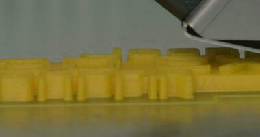 Close up view of printing plastic model on a 3D printer in process video