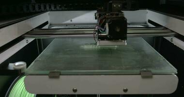 close up view of mechanism of 3d printer making white plastic object video