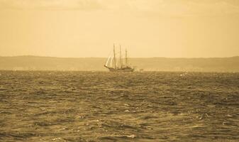 landscape with a sailing ship sailing on the blue Baltic Sea photo