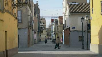 Street with old houses and few people in Valencia, Spain video