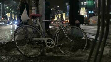 Bike in street of night winter city People and transport traffic in background video