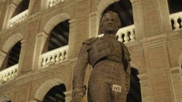 Statue of Toreador Manolo Montoliu on Plaza de Toros in night Valencia video