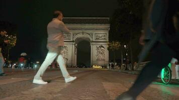 People on crosswalk in evening Paris, view to Arc de Triomphe video